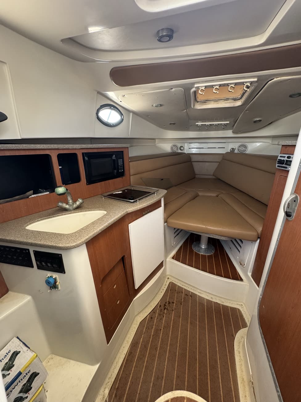 Cabin interior with V-berth seating, table, and galley counter