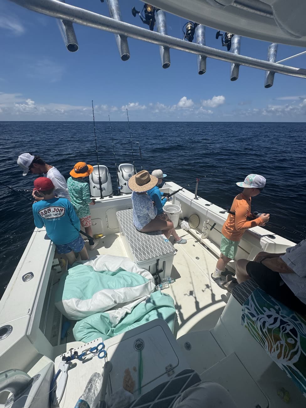 Kids and parents fishing off the stern on a family charter